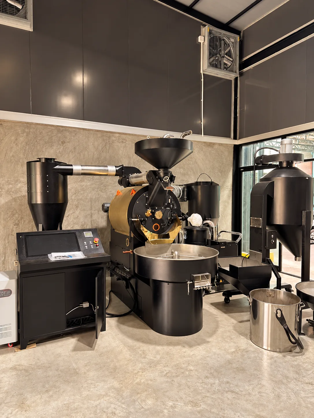 Coffee roaster and cooling tray at the Happy Roastery roastery